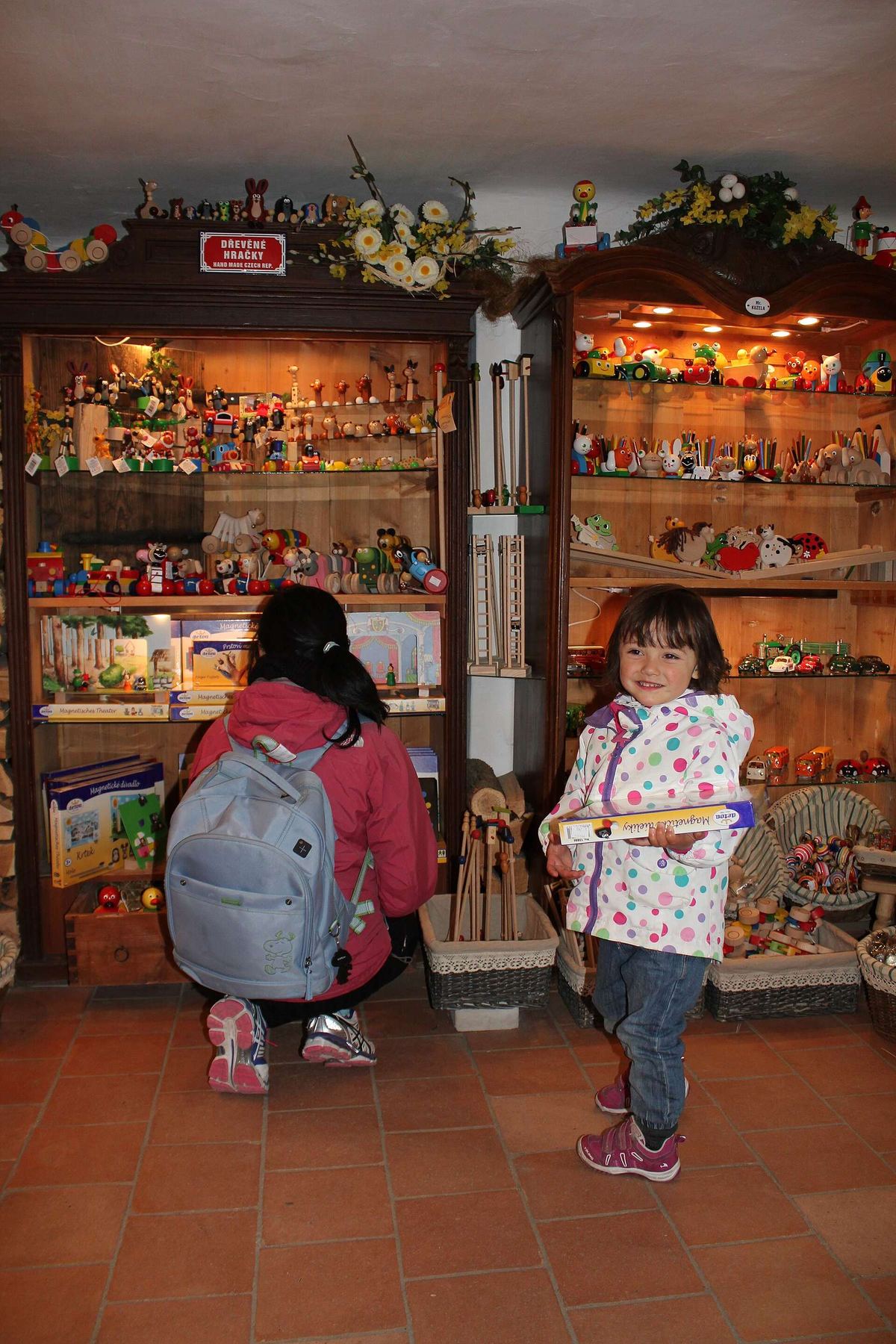 Two children exploring the shelves of a toy shop