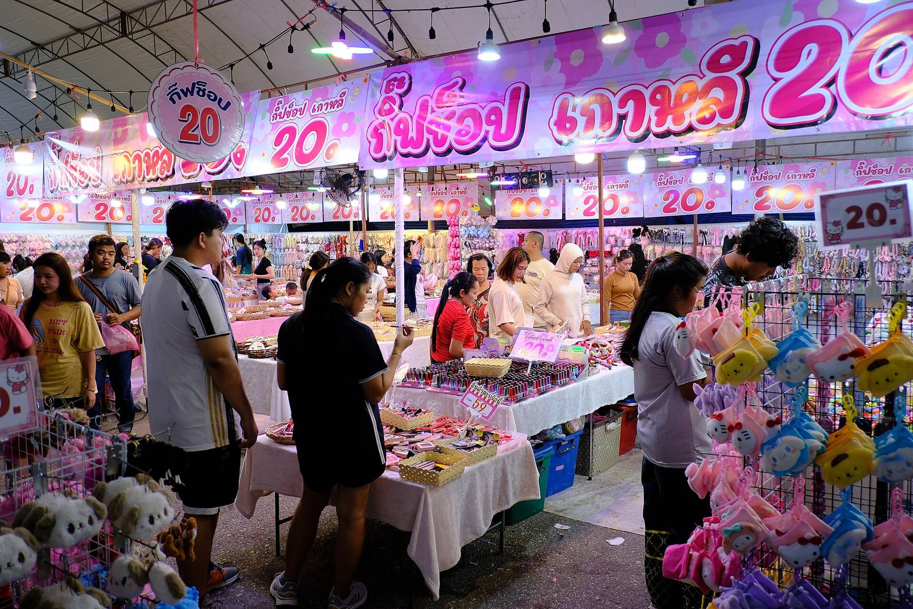 A busy night market with stalls of plush toys