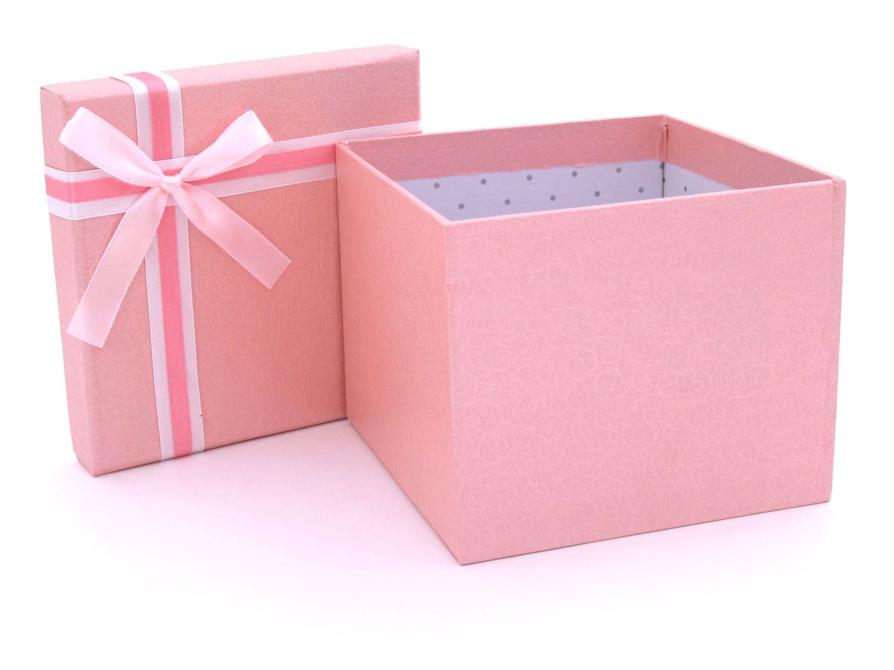 An open pink gift box with its ribbon-tied lid