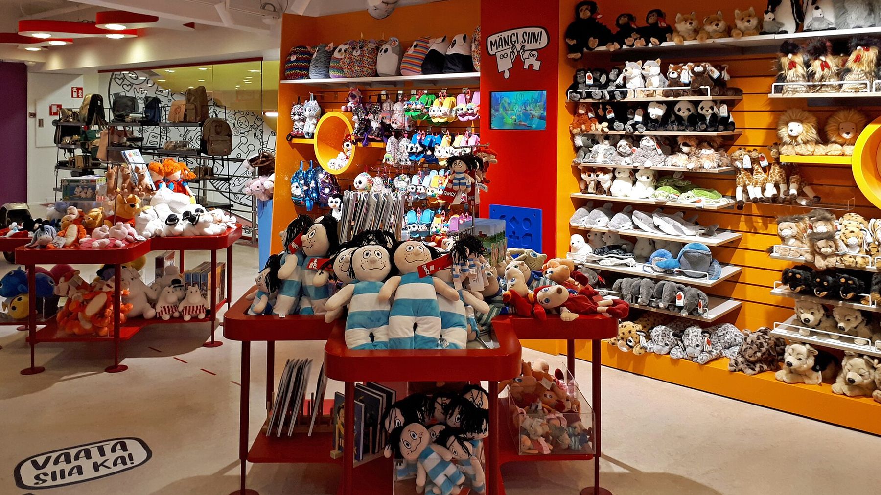 Inside a toy store with shelves full of plush toys