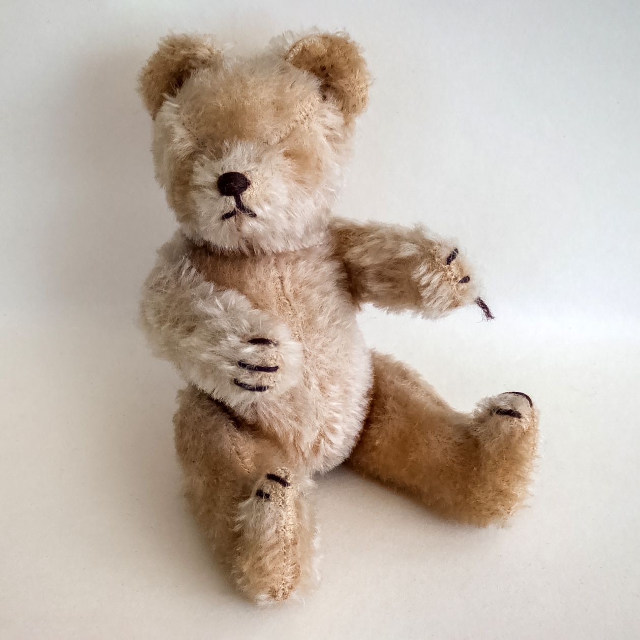 A jointed vintage-style mohair teddy bear